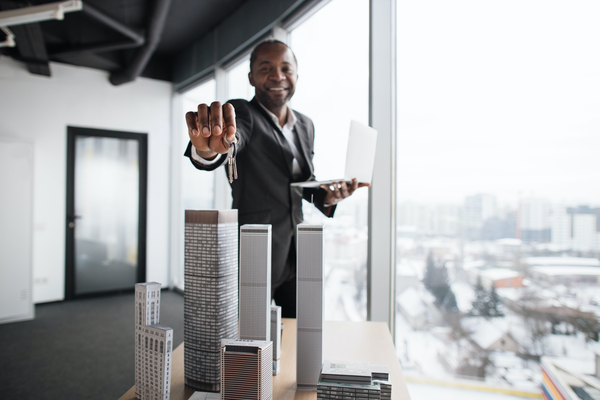 Focus on keys in hand of african real estate manager homeowner businessman banker