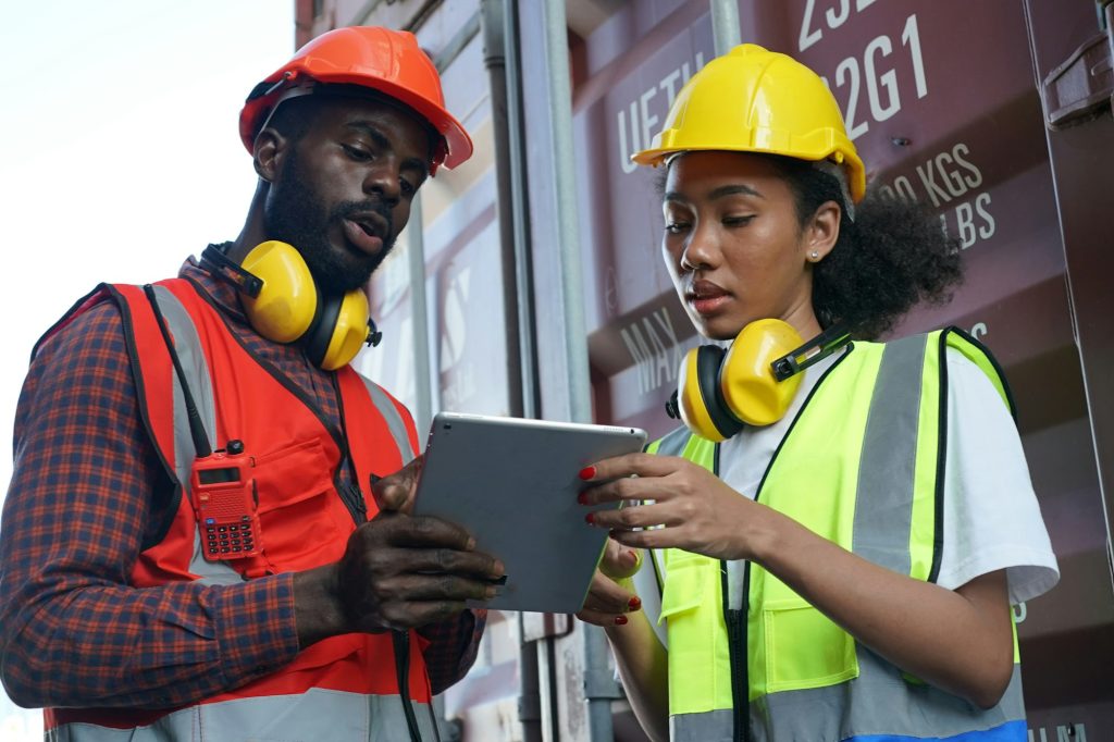 foreman checking containers in the terminal, at import and export business logistic company.